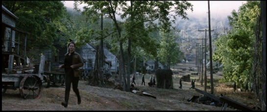 shot 6 long shot of Katniss with miners in background